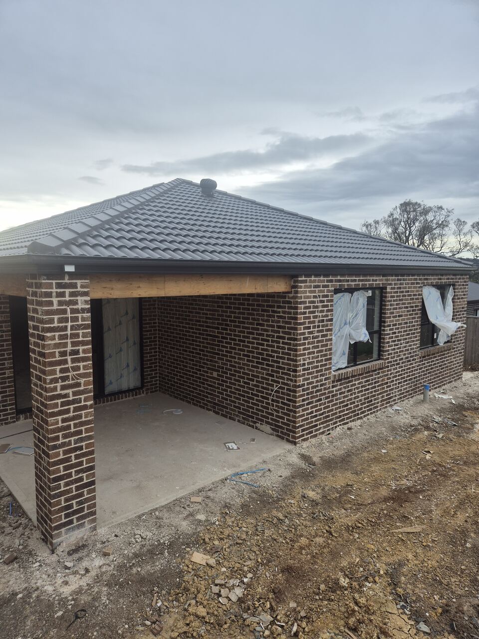 Ladhams Way at lock-up stage, with brown brick walls, a tiled roof and windows in